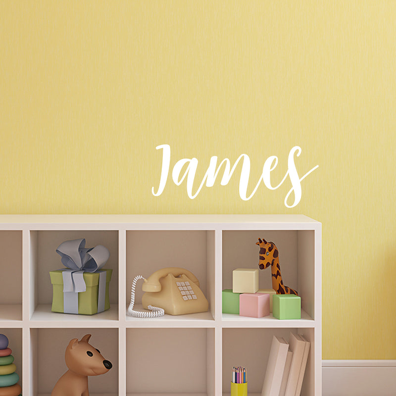 Vinyl Wall Art Decal Boys Custom Name - ’James’ Custom Text Name - 12" x 34" - Little Boys Bedroom Vinyl Wall Decals - Cute Wall Art Decals for Baby Boy Nursery Room Decor (12" x 34"; White Cursive) 1